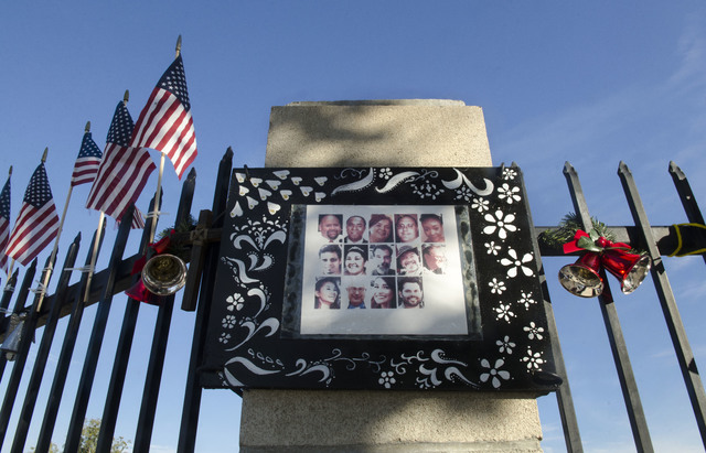 A photo collage showing images of the 14 victims who were killed in the Dec. 2, 2015, San Bernardino terror attack is hung at a makeshift memorial near the Inland Regional Center in San Bernardino ...