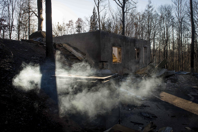 Smoke billows from the remains of a home on the northern outskirts of Gatlinburg, Tenn., Thursday, Dec. 1, 2016. (Andrew Nelles/The Tennessean via AP)