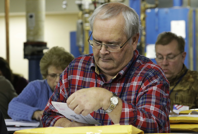 Workers begin a statewide presidential election recount Thursday, Dec. 1, 2016, in Milwaukee. The first candidate-driven statewide recount of a presidential election in 16 years began Thursday in ...