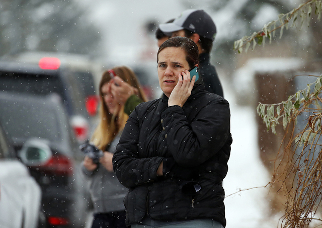 Shelly Craven, who has a son at Mueller Park Junior High School, waits in Bountiful, Utah, on Thursday, Dec. 1, 2016, to learn what is happening as officials respond after a student fired a gun in ...
