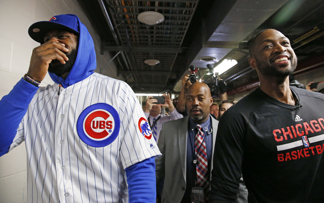 Cleveland Cavaliers' LeBron James, left, and Chicago Bulls' Dwyane Wade smile as they walk on the hallway before an NBA basketball game Friday, Dec. 2, 2016, in Chicago. (AP Photo/Nam Y. Huh)