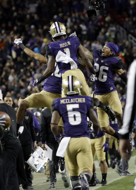 Washington wide receiver John Ross (1) celebrates his touchdown catch with teammates, including Sidney Jones (26) and Chico McClatcher (6), during the second half of the Pac-12 Conference champion ...