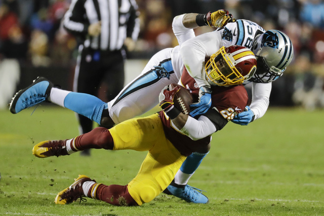 Carolina Panthers outside linebacker Thomas Davis (58) stops Washington Redskins running back Chris Thompson (25) during the first half of an NFL football game in Landover, Md., Monday, Dec. 19, 2 ...