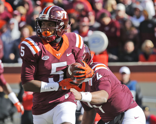 Virginia Tech wide receiver Cam Phillips (5) gets a handoff from quarterback Jerod Evans (4) during the first half of an NCAA college football game in Blacksburg, Va., Saturday, Nov. 26, 2016. (St ...