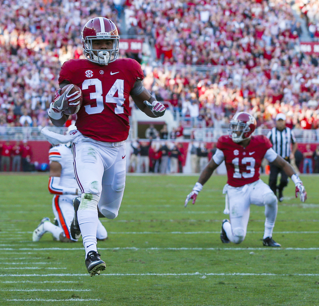 Alabama running back Damien Harris (34) runs in for a touchdown during the first half of the Iron Bowl NCAA football game against Auburn, Saturday, Nov. 26, 2016, in Tuscaloosa, Ala. (Butch Dill/AP)