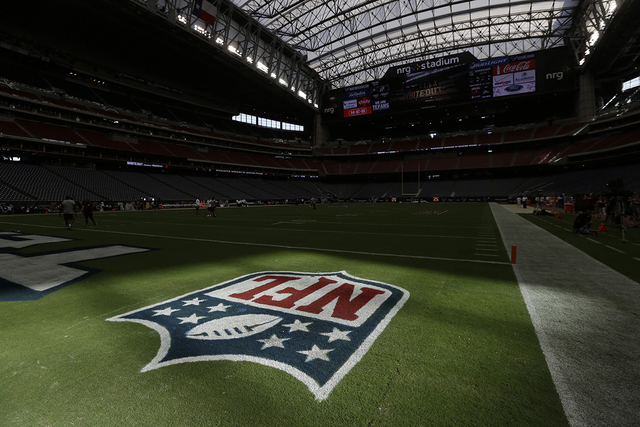 Sunlight hits the NFL logo on the field at NRG Stadium before an NFL football game Sunday between the Houston Texans and Washington Redskins, Sept. 7, 2014, in Houston. (David J. Phillip/AP)
