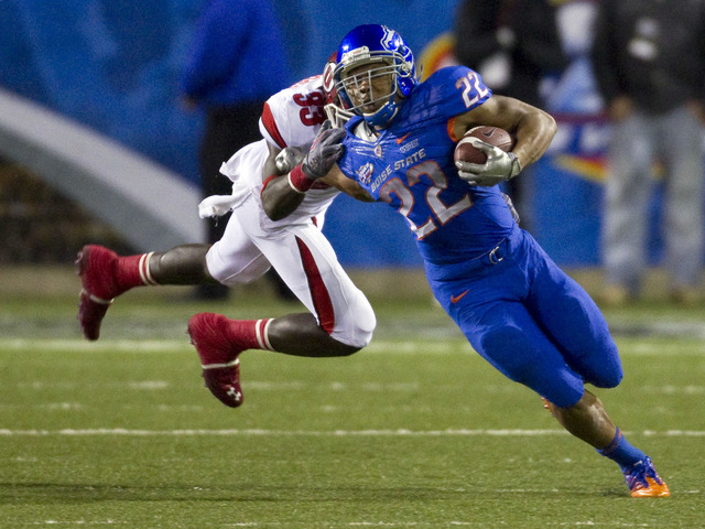 Boise State running back Doug Martin (22) is brought down by Utah defensive back Justin Taplin-Ross during the first half of the Maaco Bowl NCAA college football game, Wednesday Dec. 22, 2010, in ...