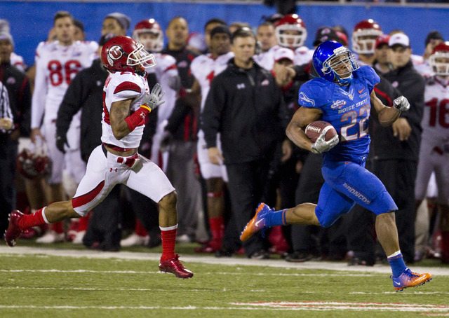 Boise State running back Doug Martin, right, runs 84 yards for touchdown as Utah's Lamar Chapman chases during the first half of the Maaco Bowl NCAA college football game, Wednesday Dec. 22, 2010, ...