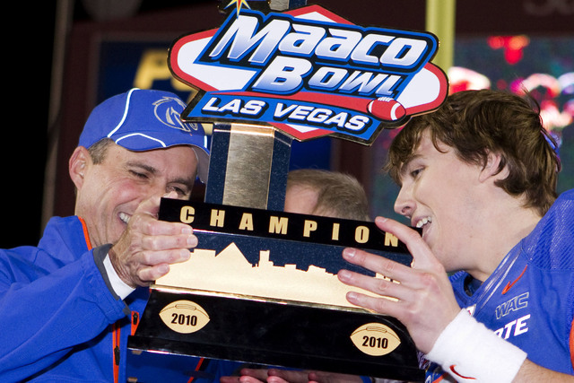 Boise State head coach Chris Peterson and quarterback Kellen Moore celebrate their 26-3 win over Utah in the Maaco Bowl NCAA college football game, Wednesday, Dec. 22, 2010, in Las Vegas. (Eric Ja ...
