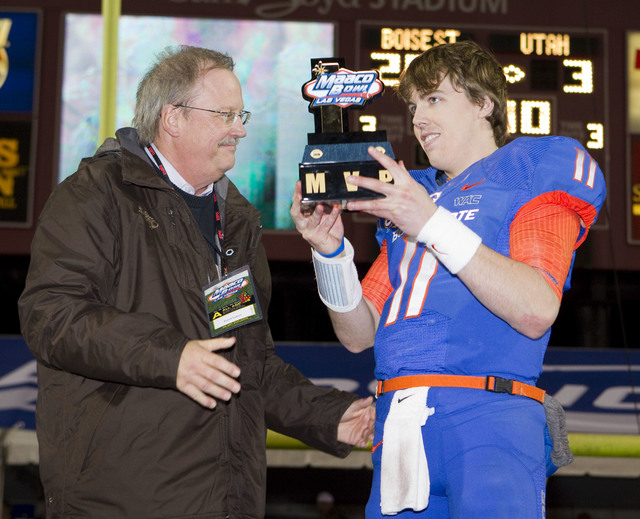 David Lapps, President and COO at Maaco Enterprises, presents Kellen Moore the MVP trophy for the Maaco Bowl NCAA college football game Wednesday Dec. 22, 2010, in Las Vegas.  Boise State defeated ...