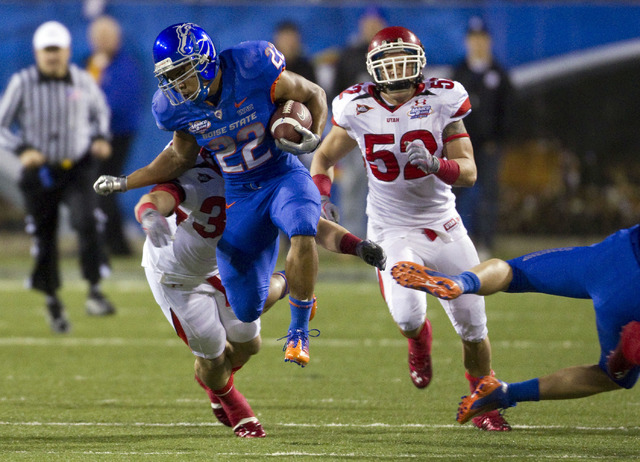 Boise State running back Doug Martin is brought down by Utah's Chaz Walker (32) and Matt Martinez (52) during the the first half of the Maaco Bowl NCAA college football game , Wednesday Dec. 22, 2 ...