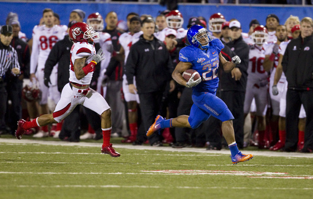 Boise State running back Doug Martin, right, runs 84 yards for touchdown as Utah's Lamar Chapman chases during the first half of the Maaco Bowl NCAA college football game, Wednesday Dec. 22, 2010, ...