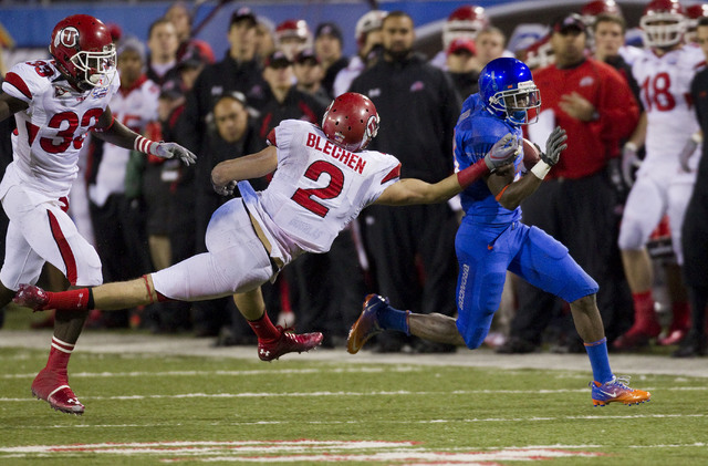 Boise State corner back Jamar Taylor is brought down by Utah defensive back Brian Blechen (2) and linebacker Chaz Walker during the second half of their Maaco Bowl NCAA college football game, Wedn ...