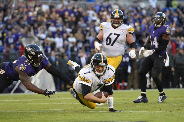 Pittsburgh Steelers quarterback Ben Roethlisberger (7) dives past Baltimore Ravens outside linebacker Terrell Suggs, left, for a touchdown in the second half of an NFL football game, Sunday, Nov. ...