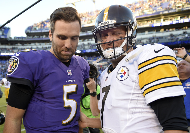 Baltimore Ravens quarterback Joe Flacco, left, and Pittsburgh Steelers quarterback Ben Roethlisberger walk off the field after talking following an NFL football game, Sunday, Nov. 6, 2016, in Balt ...