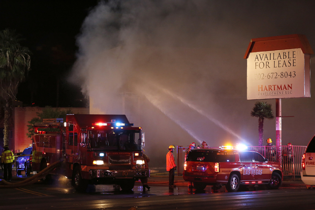 Las Vegas Fire & Rescue crews attack a two-alarm fire near Charleston Boulevard and 3rd Street in Las Vegas on Friday, Dec. 2, 2016. More than 60 firefighters responded. (Rachel Crosby/Las Veg ...