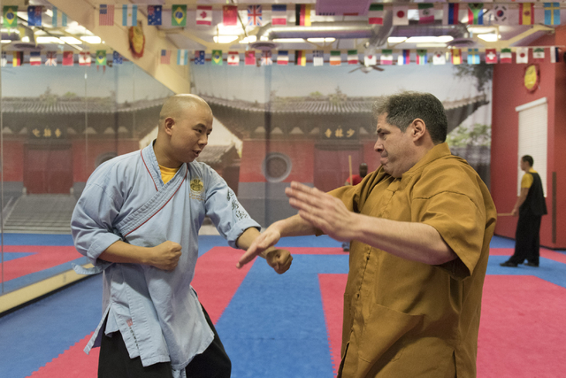 Rabbi Felipe Goodman, right, is given a kung fu lesson from shifu Shi Xing Wei at Shaolin Kungfu Chan in Las Vegas Friday, July 29, 2016. Rabbi Goodman does kung fu as a way to relieve workplace s ...