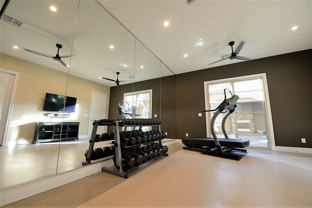 COURTESY
The dark brown accent wall gives this home gym an intimate feel.