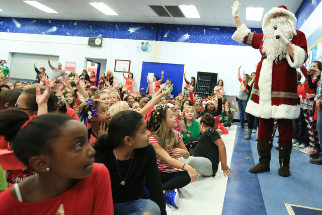 Eric Johnson as Santa talks to students before giving them gifts at C.T. Sewell Elementary School in Henderson on Friday, Dec. 16, 2016. The gifts were donated by Bob and Sandy Ellis, who have don ...