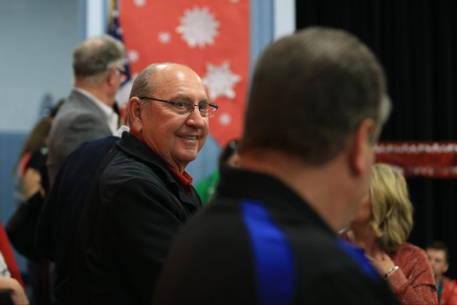 Bob Ellis watches students before they receive gifts at C.T. Sewell Elementary School in Henderson on Friday, Dec. 16, 2016. The gifts were donated by Bob and Sandy Ellis, who have donated more th ...