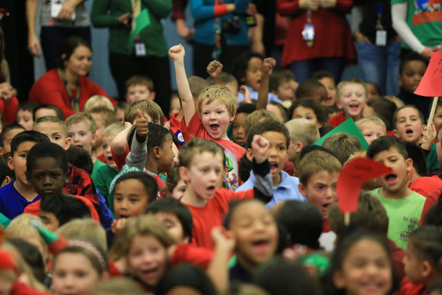 Students at C.T. Sewell Elementary School in Henderson cheer for the arrival of Santa on Friday, Dec. 16, 2016. The gifts were donated by Bob and Sandy Ellis, who have donated more than 20,000 sho ...