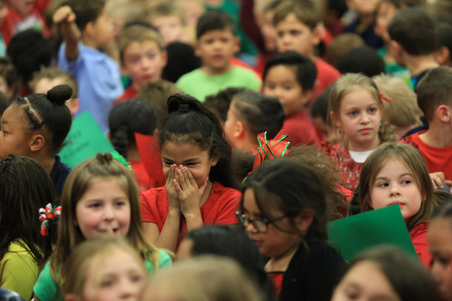 A students laughs while Santa talks at C.T. Sewell Elementary School in Henderson on Friday, Dec. 16, 2016. Gifts that were given out were donated by Bob and Sandy Ellis, who have donated more tha ...