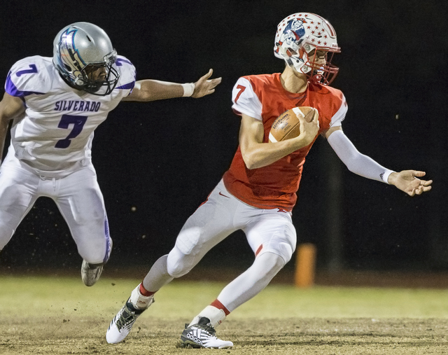 Liberty's Kenyon Oblad (7) scrambles past Silverado's Joshua Lathers (7 ) during the Sunrise Region semifinal game on Thursday, Nov. 10, 2016, at Liberty High School, in Las Henderson. (Benjamin H ...