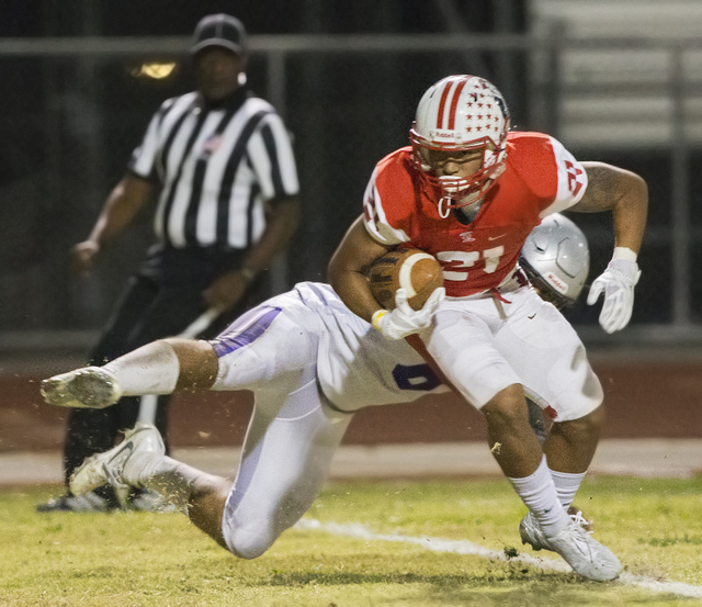 Liberty's Darion Acohido (21) fights for extra yardage with a Silverado defender on his back during the Sunrise Region semifinal game on Thursday, Nov. 10, 2016, at Liberty High School in Henderso ...