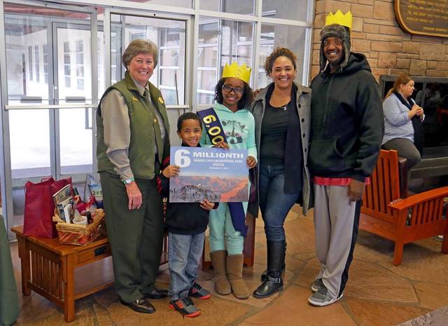 Grand Canyon National Park superintendent Chris Lehnertz, left, poses with James and Abigail Johnson and their children, Sophia and Elijah at park headquarters Monday. The Johnson family from Las  ...