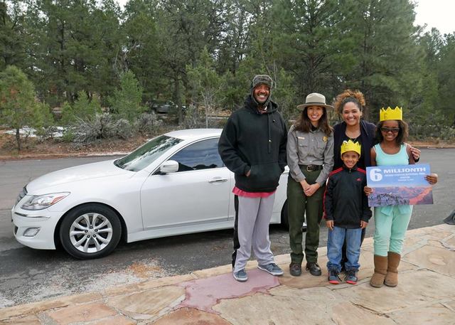 Las Vegas couple James and Abigail Johnson and their children, Sophia and Elijah, pose Monday with a National Park Service employee after being named the record 6th million visitors to Grand Canyo ...