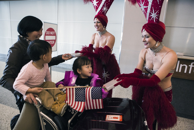 Showgirls give gifts to Hainan Airlines passengers after arriving at McCarran International Airport on Friday, Dec. 2, 2016. The first nonstop flight from China arrived on Friday. Jeff Scheid/Las  ...