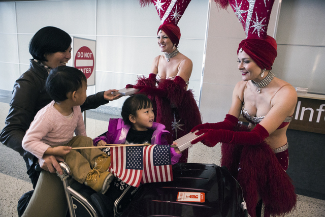 Showgirls give gifts to Hainan Airlines passengers after arriving at McCarran International Airport on Friday, Dec. 2, 2016. The first nonstop flight from China arrived on Friday. Jeff Scheid/Las ...