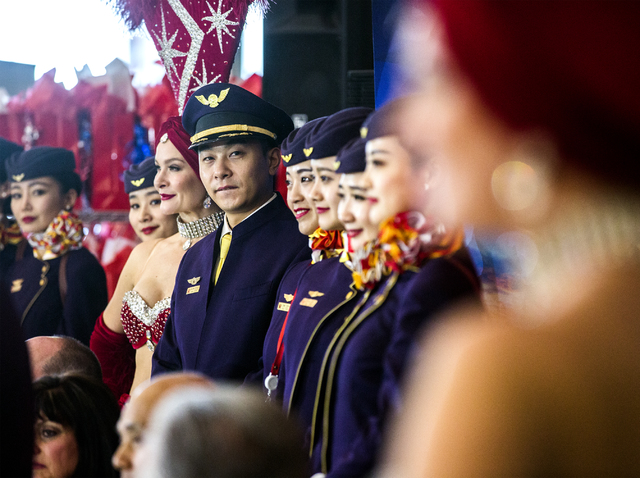 Hainan Airlines flight from Beijing stand for a photos with showgirls at McCarran International Airport on Friday, Dec. 2, 2016. The first nonstop flight from China arrived on Friday. Jeff Scheid ...
