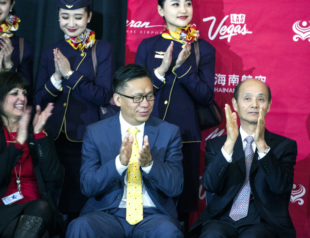 Rosemary Vassiliadis, left, director of Aviation for Clark County, Hou Wei, senior VP of Hainan Airlines, and Luo Linquan, consul general for the People's Republic of China in San Francisco, appla ...