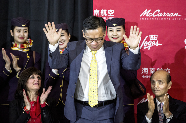 Hou Wei, center, senior VP of Hainan Airlines, bows while Rosemary Vassiliadis, left, director of Aviation for Clark County, and Luo Linquan, consul general for the People's Republic of China in S ...