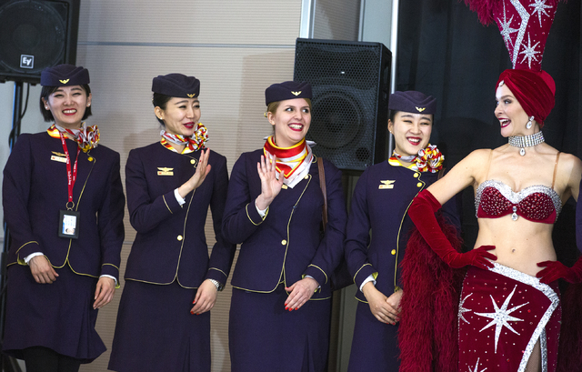 Flight attendants from Hainan Airlines wave during a inaugural flight reception at McCarran International Airport on Friday, Dec. 2, 2016. The first nonstop flight from China arrived on Friday. Je ...