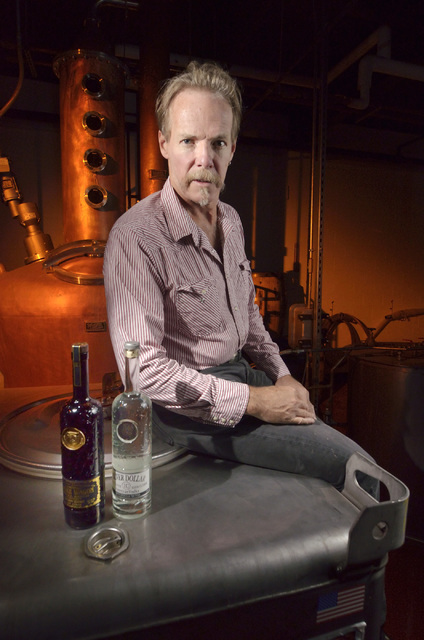 Jonathan Hensleigh, co-owner of Nevada H & C Distilling Co., poses next to the copper pots used to distill H & C's Silver Dollar vodka. Bill Hughes/Las Vegas Review-Journal