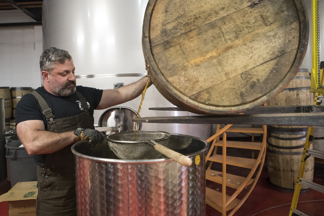 Co-owner of the Nevada H&C Distilling Co., Aaron Chepenik, dumps bourbon out of the barrel on Tuesday, Oct. 18, 2016, in Las Vegas. Loren Townsley/Las Vegas Review-Journal Follow @lorentownsley