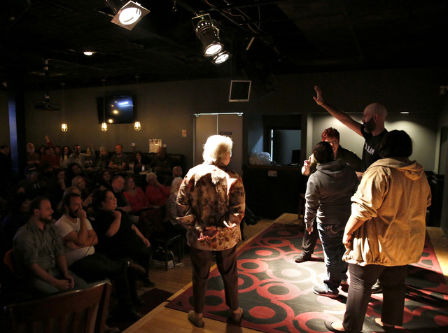 Douglas Ridloff performs on stage with audience members during ASL SLAM at E-String Grill and Poker Bar in Henderson on Dec. 3, 2016. ASL SLAM is a space for Deaf performing artists to share poetr ...