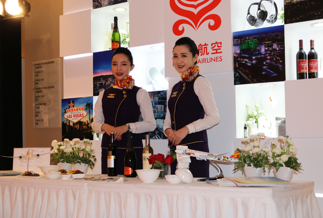 Hainan Airlines flight attendants Ashley Fan, left, and April Lu welcome guests at a launch party for Hainan Airlines' nonstop service from Beijing to Las Vegas. Hainan Airlines and the LVCVA host ...