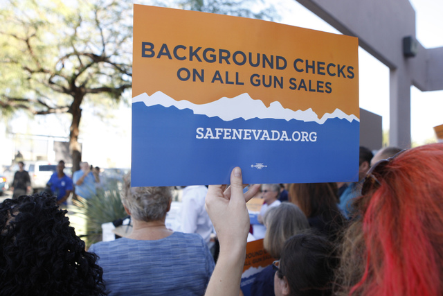 Volunteers with Nevadans for Background Checks stand outside of the Clark County Election Center in North Las Vegas during a press conference on Wednesday, Nov. 12, 2014. (Erik Verduzco/Las Vegas ...