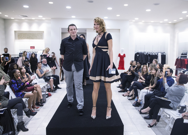 Designer Brenton Coon, left, and model Katharine Taylor celebrate winning the "Little Black Dress" event at Saks Fifth Avenue on Thursday, Nov. 17, 2016, at Fashion Show Mall, in ...
