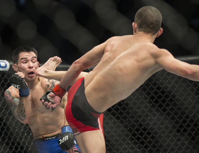 Ray Borg ducks a kick against Louis Smolka during their flyweight fight at UFC 207 at T-Mobile Arena on Friday, Dec. 30, 2016, in Las Vegas. Benjamin Hager/Las Vegas Review-Journal