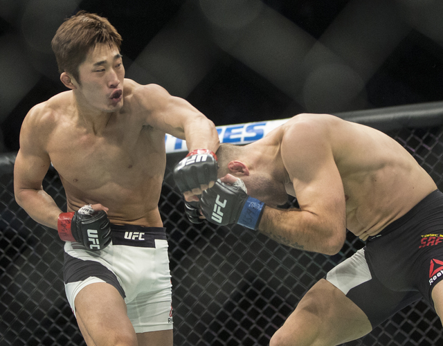 Dong Hyun Kim lands a strike against Tarec Saffiedine during their welterweight fight at UFC 207 at T-Mobile Arena on Friday, Dec. 30, 2016, in Las Vegas. Benjamin Hager/Las Vegas Review-Journal