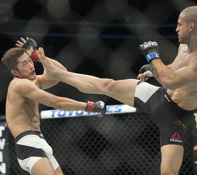 Tarec Saffiedine lands a kick against Dong Hyun Kim during their welterweight fight at UFC 207 at T-Mobile Arena on Friday, Dec. 30, 2016, in Las Vegas. Benjamin Hager/Las Vegas Review-Journal