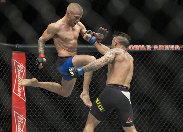 TJ Dillashaw lands a flying knee against John Lineker during their bantamweight fight at UFC 207 at T-Mobile Arena on Friday, Dec. 30, 2016, in Las Vegas. Benjamin Hager/Las Vegas Review-Journal