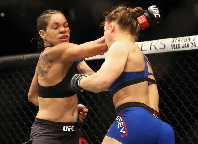 Amanda Nunes lands a strike against Ronda Rousey during their bantamweight championship fight at UFC 207 at T-Mobile Arena on Friday, Dec. 30, 2016, in Las Vegas. Benjamin Hager/Las Vegas Review-J ...
