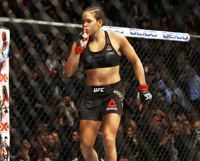 Amanda Nunes celebrates after defeating Ronda Rousey by TKO in the first round during their bantamweight championship fight at UFC 207 at T-Mobile Arena on Friday, Dec. 30, 2016, in Las Vegas. Ben ...