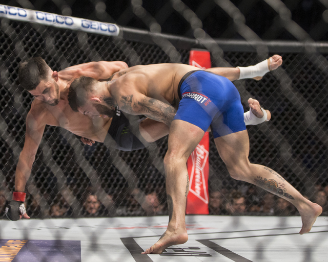 Cody Garbrandt, right, takes down Dominick Cruz during their bantamweight fight at UFC 207 at T-Mobile Arena on Friday, Dec. 30, 2016, in Las Vegas. Benjamin Hager/Las Vegas Review-Journal