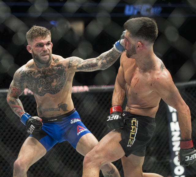 Cody Garbrandt, left, lands a strike against Dominick Cruz during their bantamweight fight at UFC 207 at T-Mobile Arena on Friday, Dec. 30, 2016, in Las Vegas. Benjamin Hager/Las Vegas Review-Journal